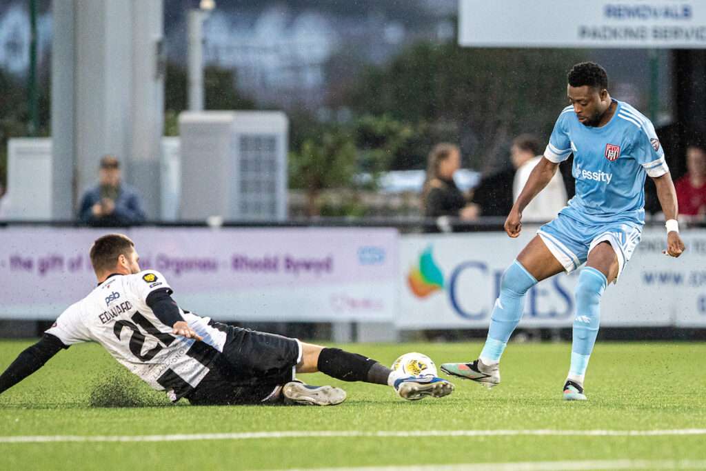 LLANDUDNO, WALES - 31 JULY 2026: Llandudno's Kai Edwards and Flint Town United's Tunde Owolabi battle for the ball during the 2026-27 Novira Cymru Premier match between Llandudno and Flint Town United at Go Goodwins Stadium, Llandudno, Wales. (Pic by Nik Mesney/FAW)