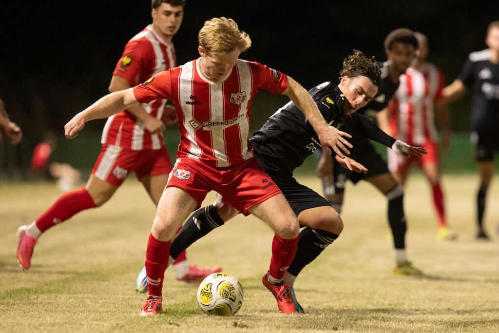 A battle for possession during the 2026-27 Novira Cymru Premier match between Holywell Town and Connah's Quay Nomads at Bartons North Wales Stadium, Holywell, Wales