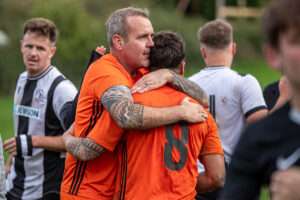 Stuart Roberts and Ryan Roberts of Llysfaen celebrate their victory following the 2026-27 FAW Welsh Cup match between Llysfaen and Barmouth and Dyffryn Utd at The Bananabeu, Llysfaen, Wales