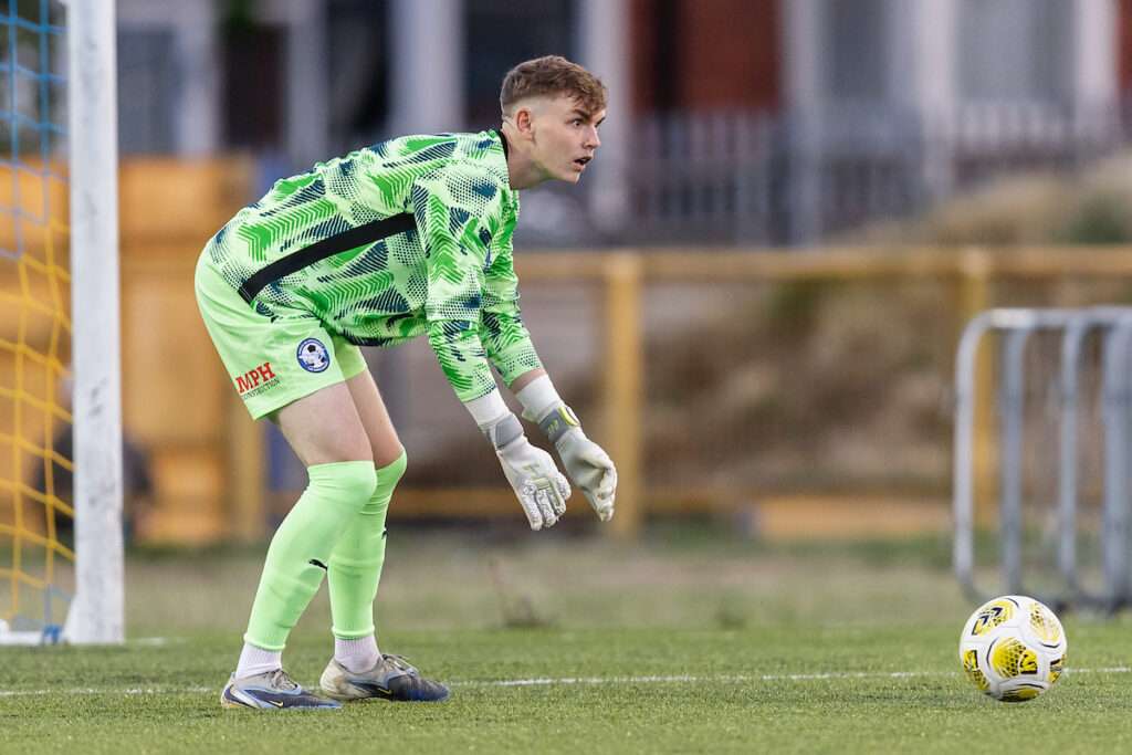 Airbus UK Broughton goalkeeper Louis Fallon during the 2026/27 Novira Cymru Premier fixture between Barry Town United FC & Airbus UK Broughton FC at Jenner Park Stadium, Barry Wales