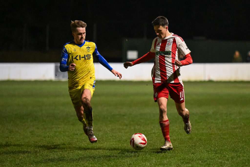 Jake Cooke of Holywell Town makes a break with the ball during the 2024/25 JD Cymru North fixture between Holywell Town & Colwyn Bay at Bartons North Wales Stadium, Holywell, Wales
