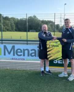 Aaron Rowlands shakes hands with Tom Clarke at his Menai Bridge Tigers unveiling