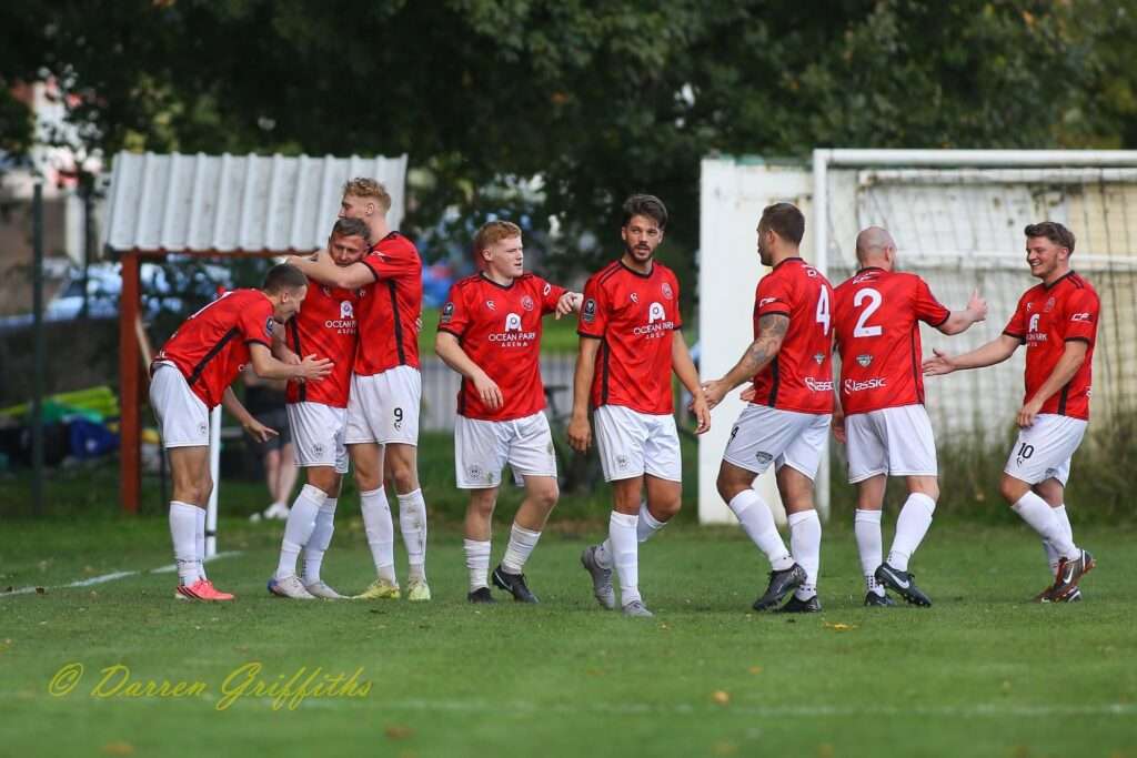 Caerau Ely players celebrate Lewis Harling's second goal against Cardiff Dracs in a Cymru South match
