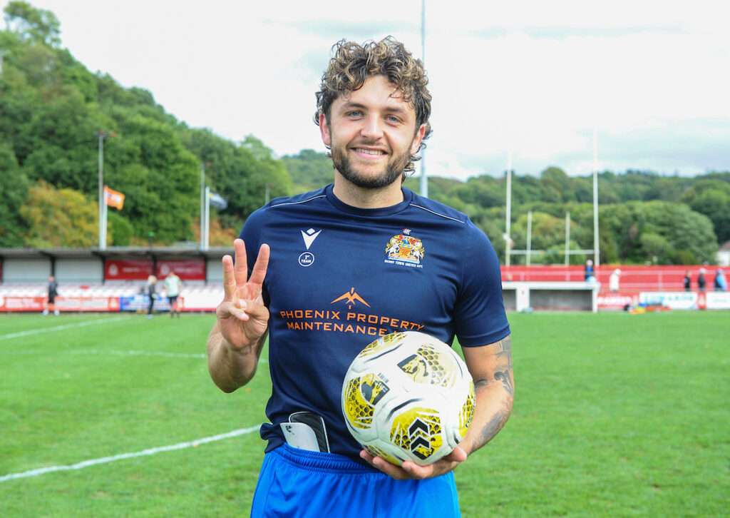 Barry Town's Elliot Dugan celebrates with the match ball at the final whistle