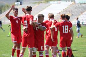A Cymru South XI side celebrate scoring in the Regions Cup