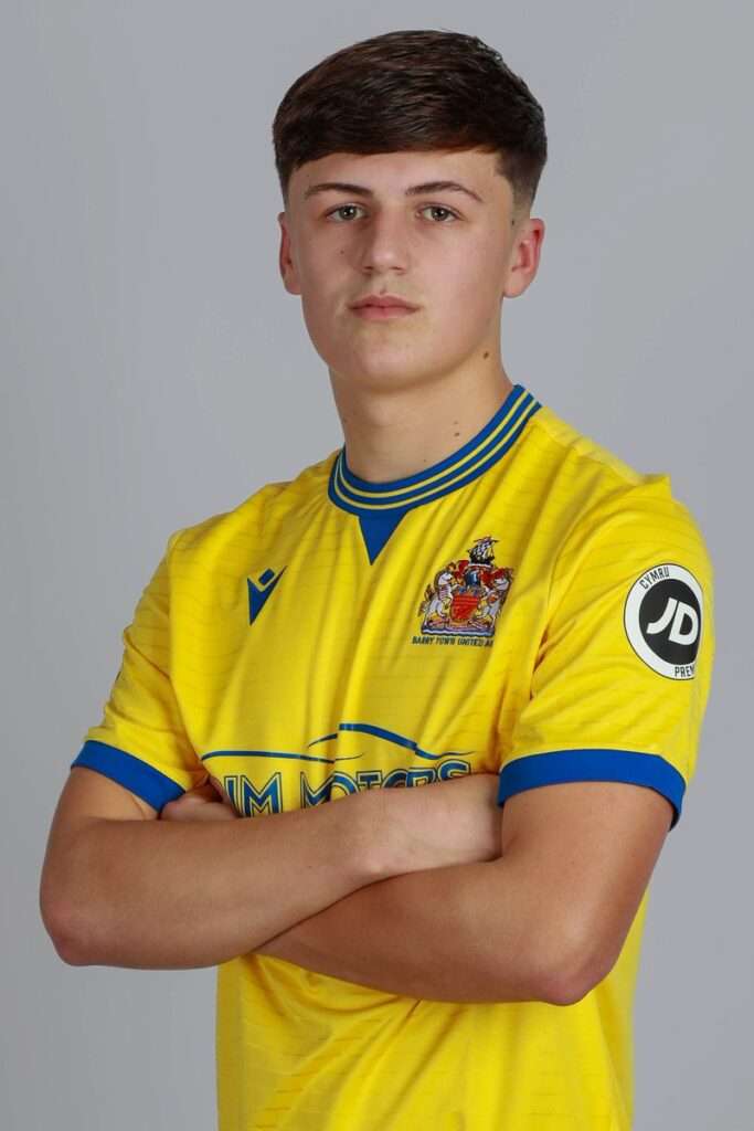 Keegan Saunders poses in a Barry Town United shirt