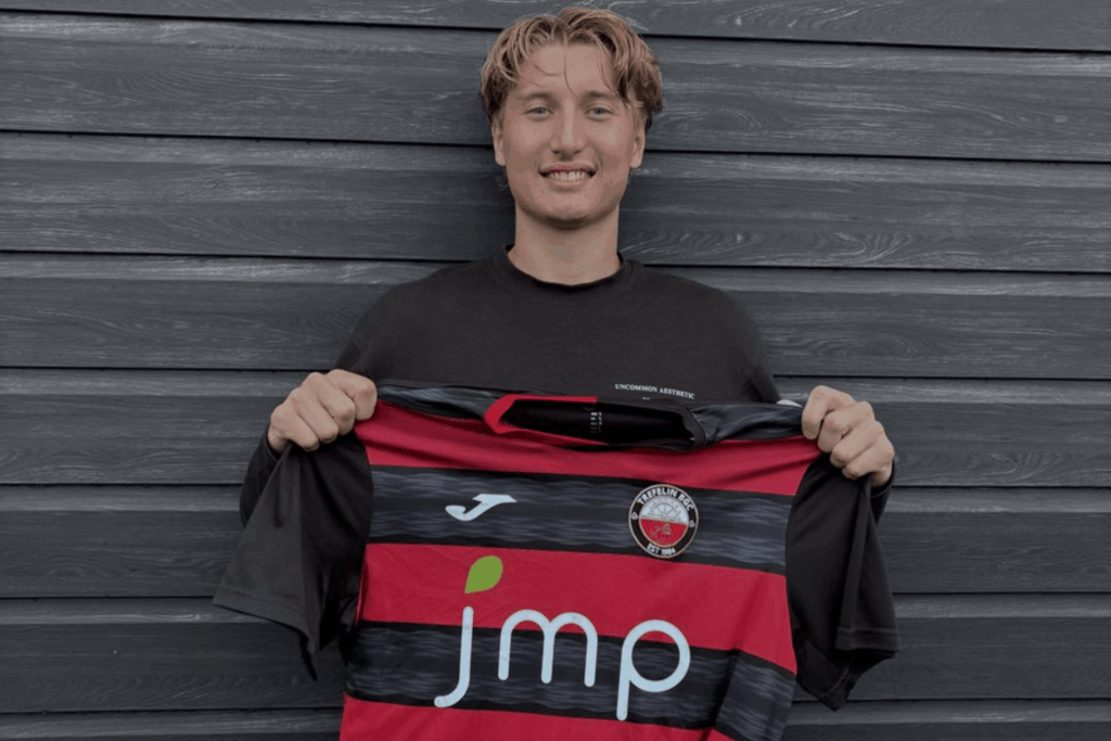 Owen Degelman poses with a Cymru Premier Tredelin shirt