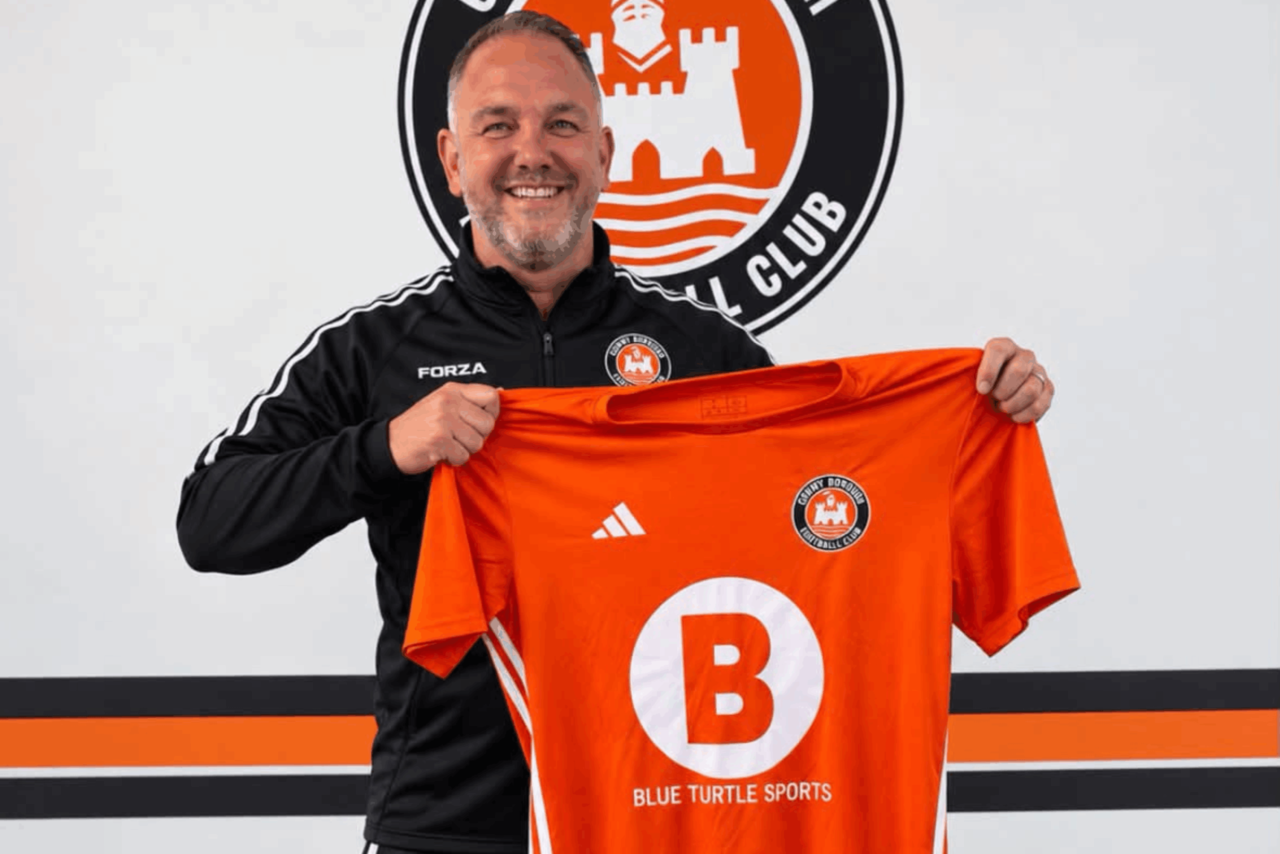 Ronnie Green holds up a Conwy Borough shirt