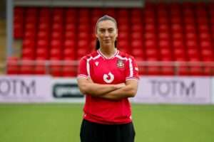 Millie Davies poses in a Wrexham shirt