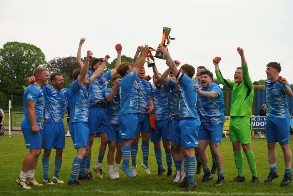 Aberbargoed Buds celebrate by lifting a cup