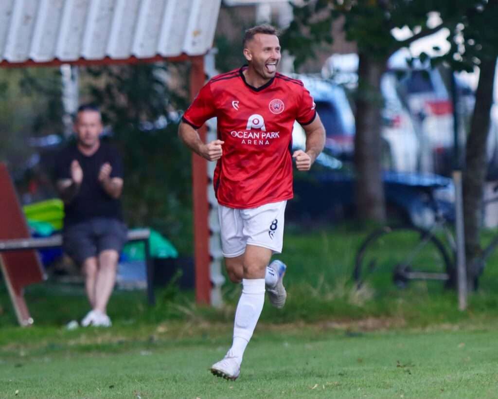 Caerau Ely's Lewis Harling celebrates his second goal against Cardiff Dracs in a Cymru South fixture