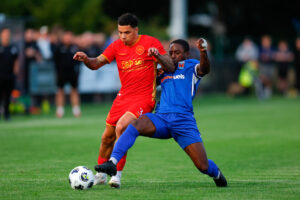 Keelan Williams of Denbigh Town and Prince Yelegon of Ruthin Town during the Novira Cymru North game between Ruthin Town and Denbigh Town at the Memorial Playing Fields, Ruthin