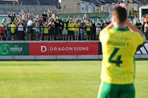 Jordan Piggott of Caernarfon Town applauds the fans after Caernarfon Town vs Colwyn Bay FC in Round 3 of the Novira Cymru Leagues Premier at The Oval, Caernarfon