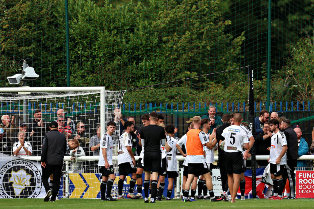 Rhyl fans after CPD Dinas Bangor 1876 vs CPD Y Rhyl 1879 in Round 7 of the Novira Cymru North at the Bangor City Stadium, Bangor