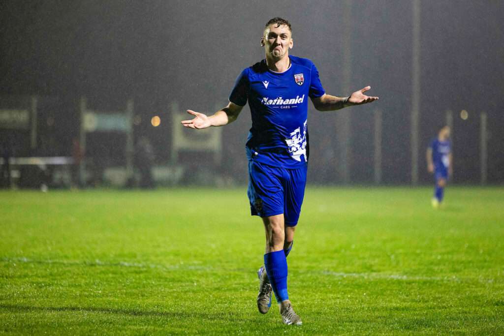 Penybont's Nathan Wood celebrates scoring his sides fourth goal during the 2026/27 Novira Cymru Premier match between Ammanford & Penybont at the Recreation Ground, Ammanford, Wales