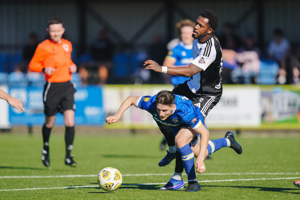 HAVERFORDWEST, WALES  - 03 OCTOBER 2026:Flint Town United's Akeel Francis and Haverfordwest County's Kyle McCarthy during the Novira Cymru Premier 2026/27 fixture Haverfordwest County vs Flint Town United at Dynamite Bridge Meadow Stadium, 