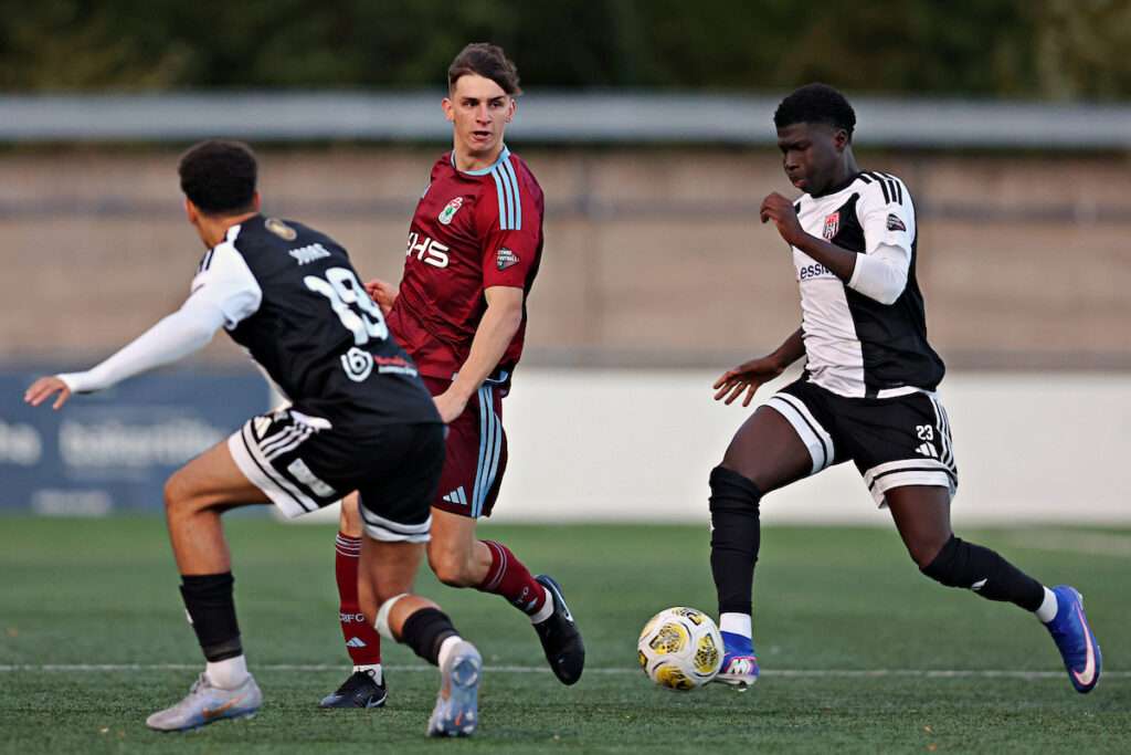 Flint Town United's Isaac Modi pressures Colwyn Bay FC's Sol Forde during Flint Town United vs Colwyn Bay FC in Round 13 of the Novira Cymru Premier at the Essity Stadium, Flint