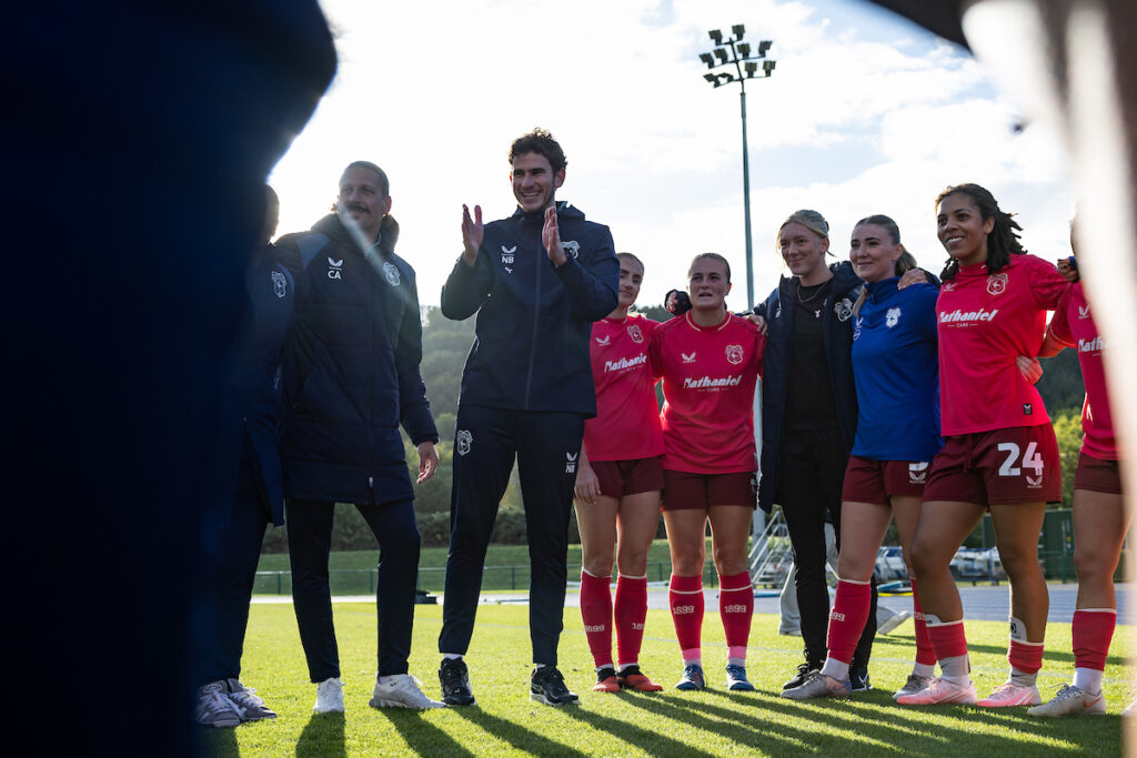 Players and staff of Cardiff City huddle at full-time as Noah Bushby Manager of Cardiff City Women gives a team talk during the Genero Adran Premier match between Cardiff City & The New Saints at the The Cardiff International Sports Stadium, Cardiff, Wales