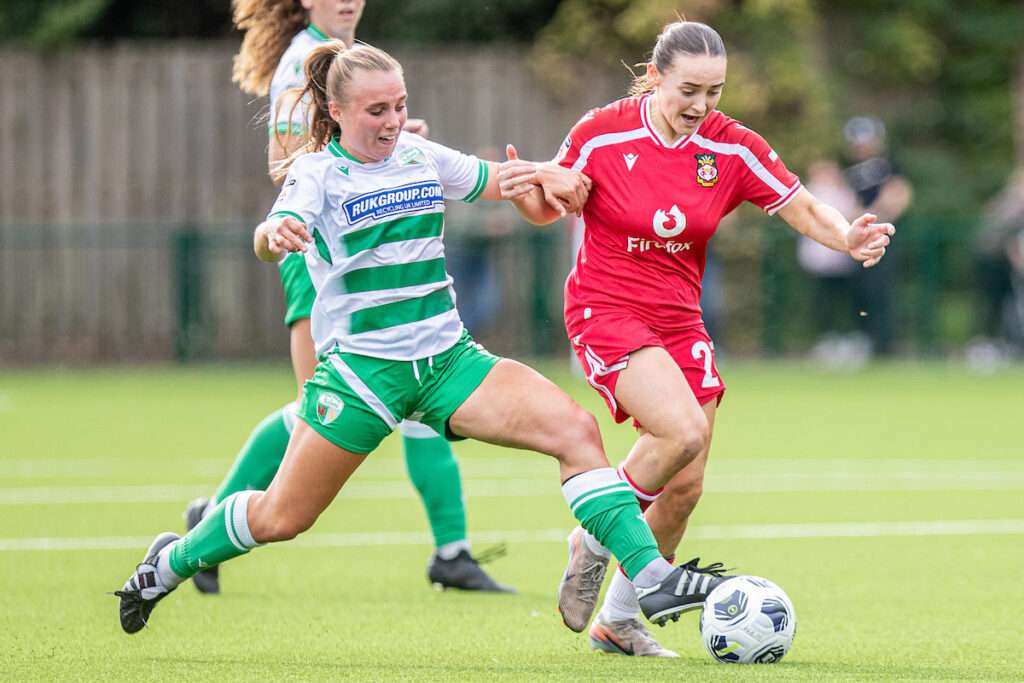 Hannah Snape of The New Saints tackles Wrexham's Maria Francis-Jones during the 2026-27 Genero Adran Premier match between Wrexham and The New Saints at The Rock, Wrexham, Wales