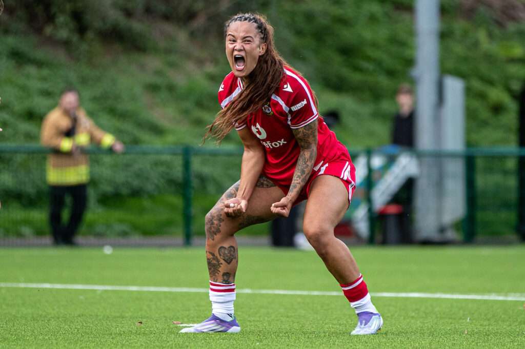 Wrexham's Natasha Thomas celebrates her late equaliser during the 2026-27 Genero Adran Premier match between Wrexham and The New Saints at The Rock, Wrexham, Wales