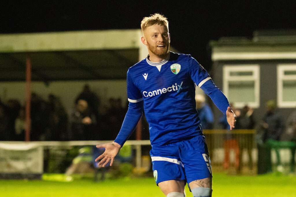 Brad Young of The New Saints opens the scoring from the penalty spot during the 2026-27 Novira Cymru Premier match between Holywell Town and The New Saints at Halkyn Road, Holywell, Wales
