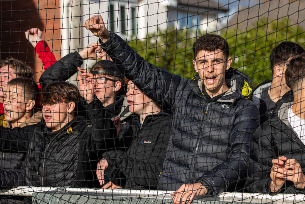 Holywell Town fans celebrate their penalty shootout victory following the FAW Welsh Cup match between Llay Welfare and Holywell Town at Llay Welfare, Llay, Wales.