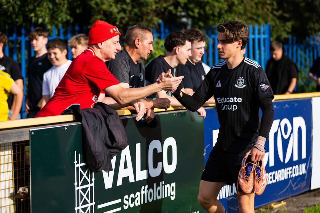 Callum West of Connah’s Quay Nomads shakes the hands of the Connah's Quay Nomads fans during the 2026/27 Novira Cymru Premier fixture between Barry Town & Connah’s Quay Nomads at the Jenner Park Stadium, Barry, Wales