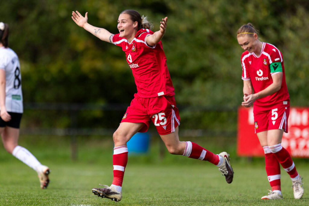 Wrexham's Mikayla Widlgoose celebrates scoring her sides eighth goal during the Genero Adran Premier match between Swansea City & Wrexham at the Garden Village Park, Swansea, Wales