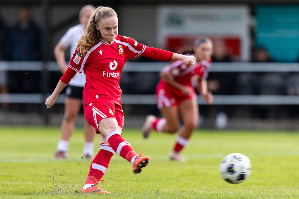 SWANSEA, WALES - 10 OCTOBER 2026: Wrexham's Katie Barker scores her sides third goal during the Genero Adran Premier match between Swansea City & Wrexham at the Garden Village Park, Swansea, Wales.