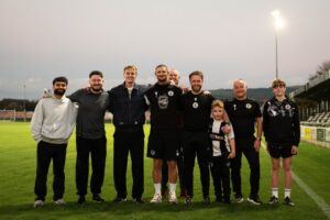 Alfie Indra and Ellis Platten with Ammanford AFC members of staff