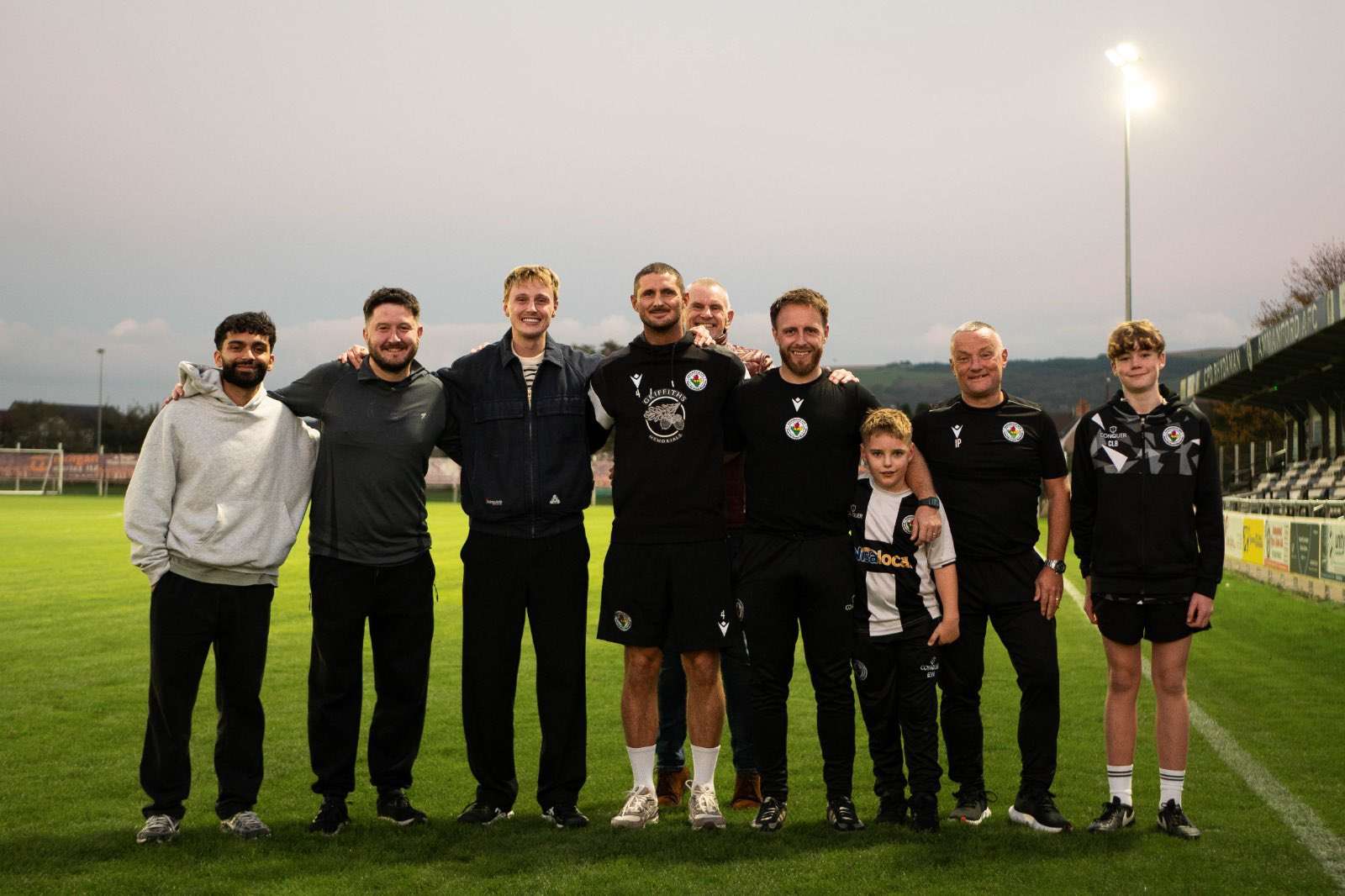 Alfie Indra and Ellis Platten with Ammanford AFC members of staff