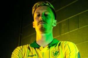 Harry Charsley poses in a Caernarfon Town shirt