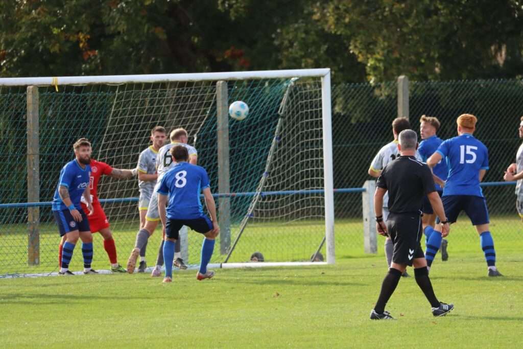 Chepstow Town's Iestyn Davies headers the ball away against Caldicot Town in the Ardal South East
