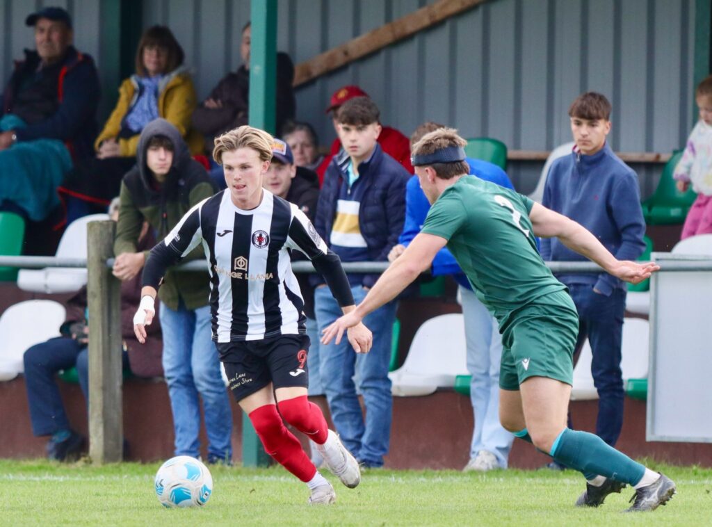 Cardiff Dracs' Cole Mace dribbles against a Radnor Valley player in the Welsh Cup