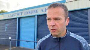 Llantwit Fardre manager Mark Minton conducts an interview after the Welsh Cup match with Baglan Dragons